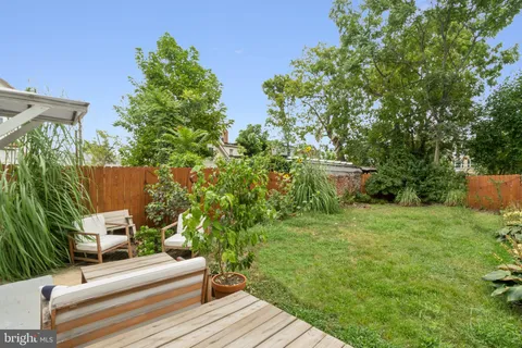 a view of backyard with sitting area