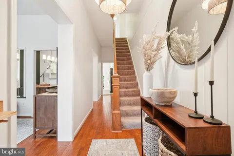a view of entryway and hall with wooden floor
