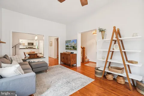 a living room with furniture and a wooden floor