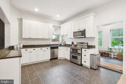 a kitchen with a stove top oven sink and cabinets