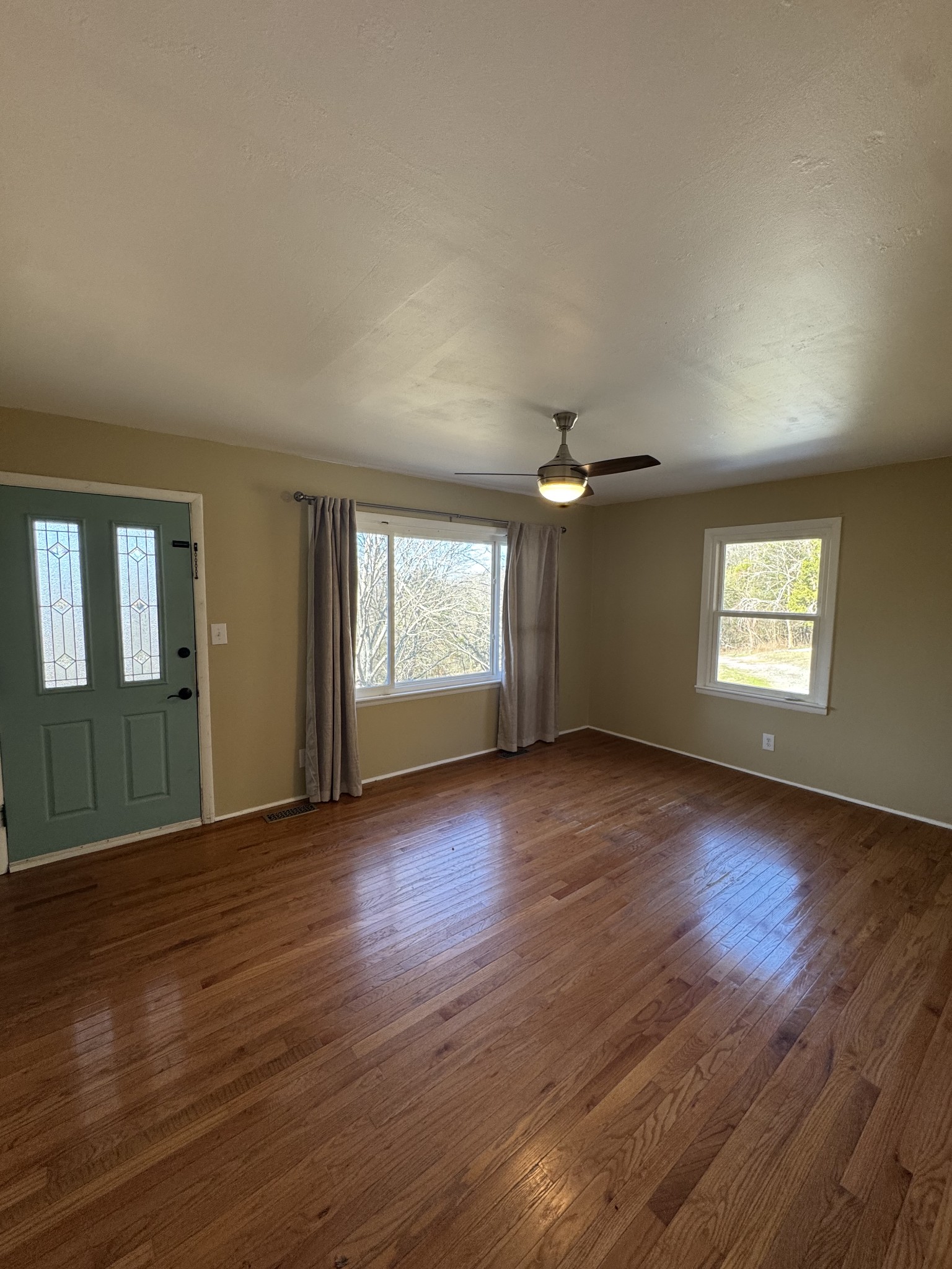 36 Hartsville Pike Carthage, TN 37030 - Photo 16 of 28 an empty room with wooden floor ceiling fan and windows
