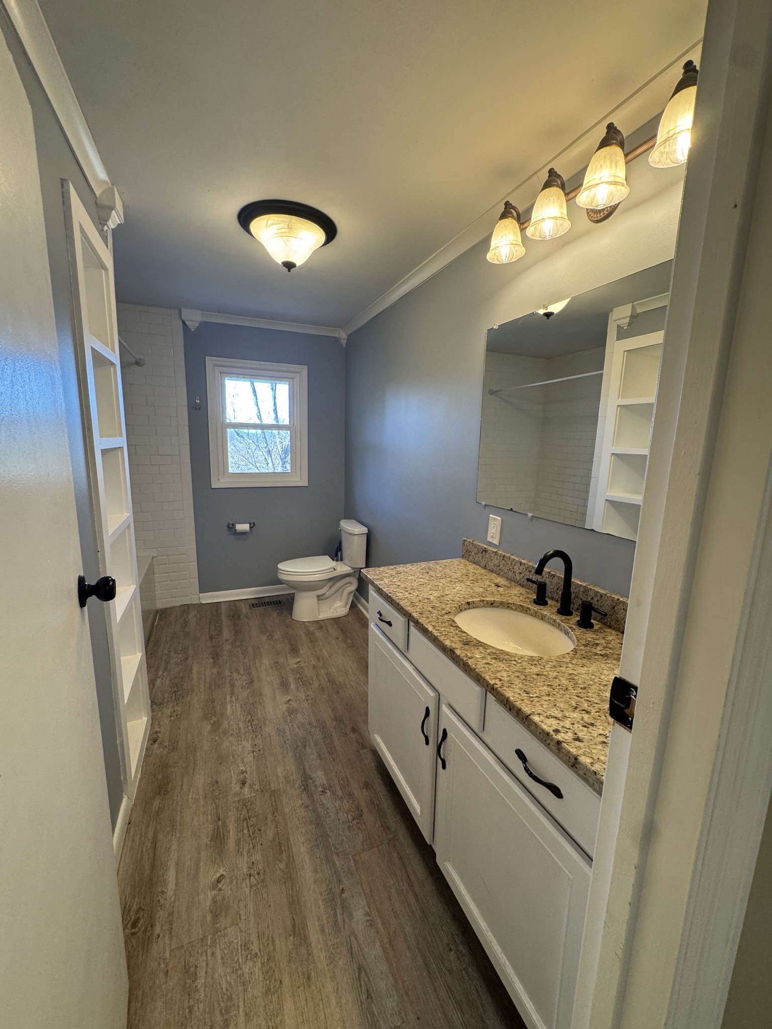 36 Hartsville Pike Carthage, TN 37030 - Photo 10 of 28 a bathroom with a sink and mirror with bathtub