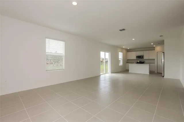 a view of empty room with windows and fireplace