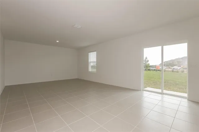 an empty room with sliding glass door