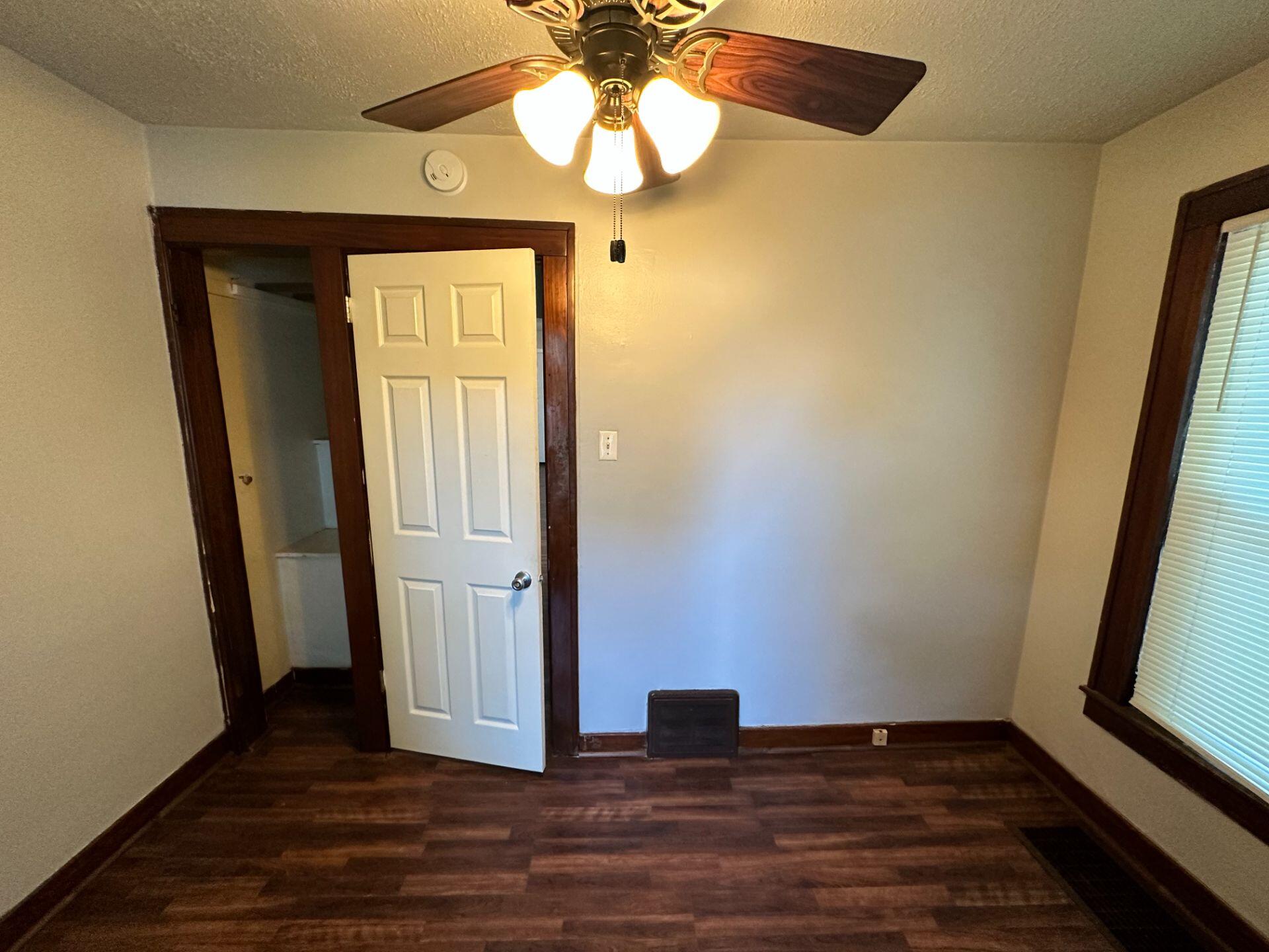 547 169th Street, Unit WEST Hammond, IN 46324 - Photo 3 of 7 a view of empty room with wooden floor and fan