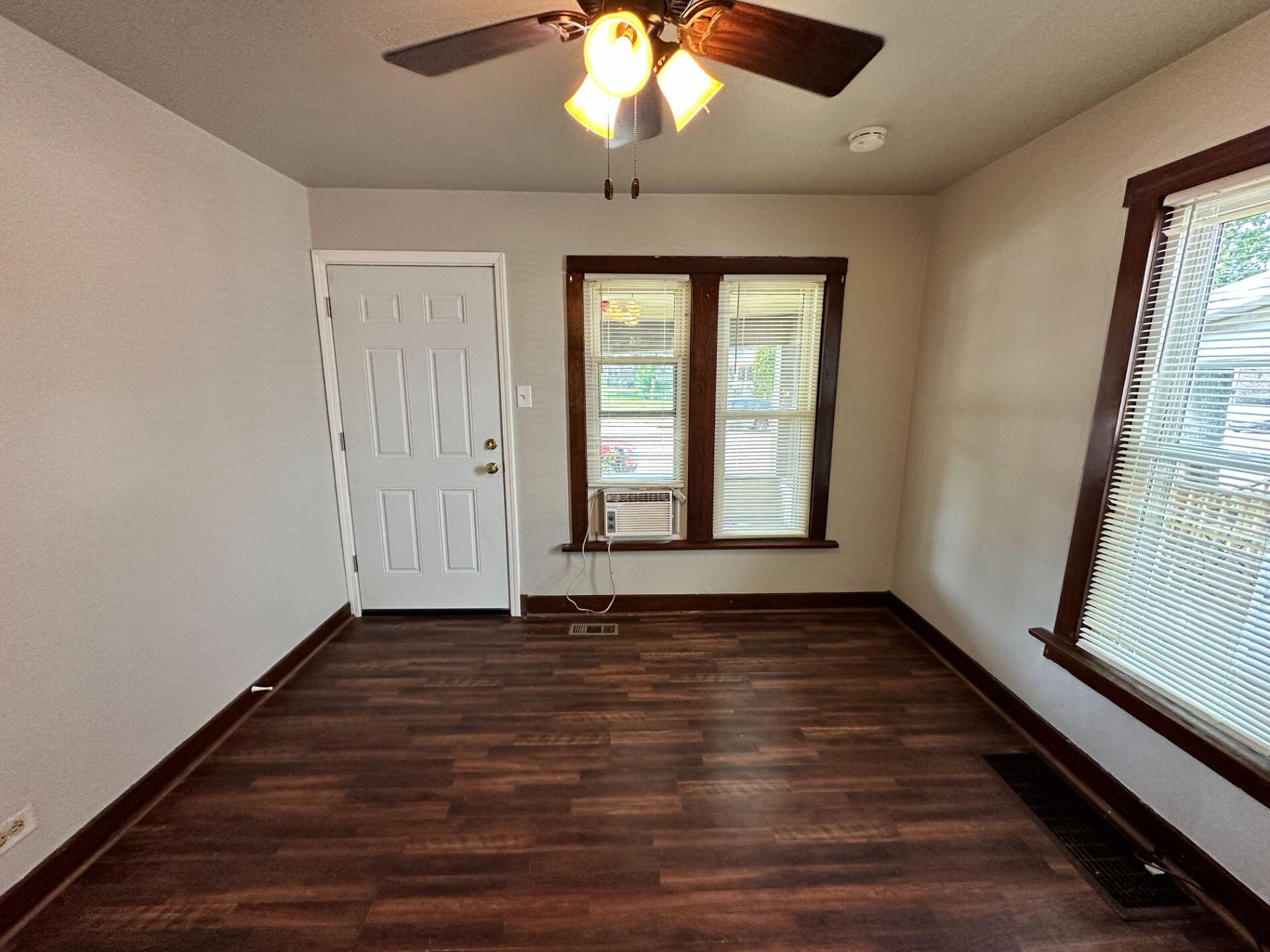 547 169th Street, Unit WEST Hammond, IN 46324 - Photo 4 of 7 a view of an empty room with wooden floor and a window