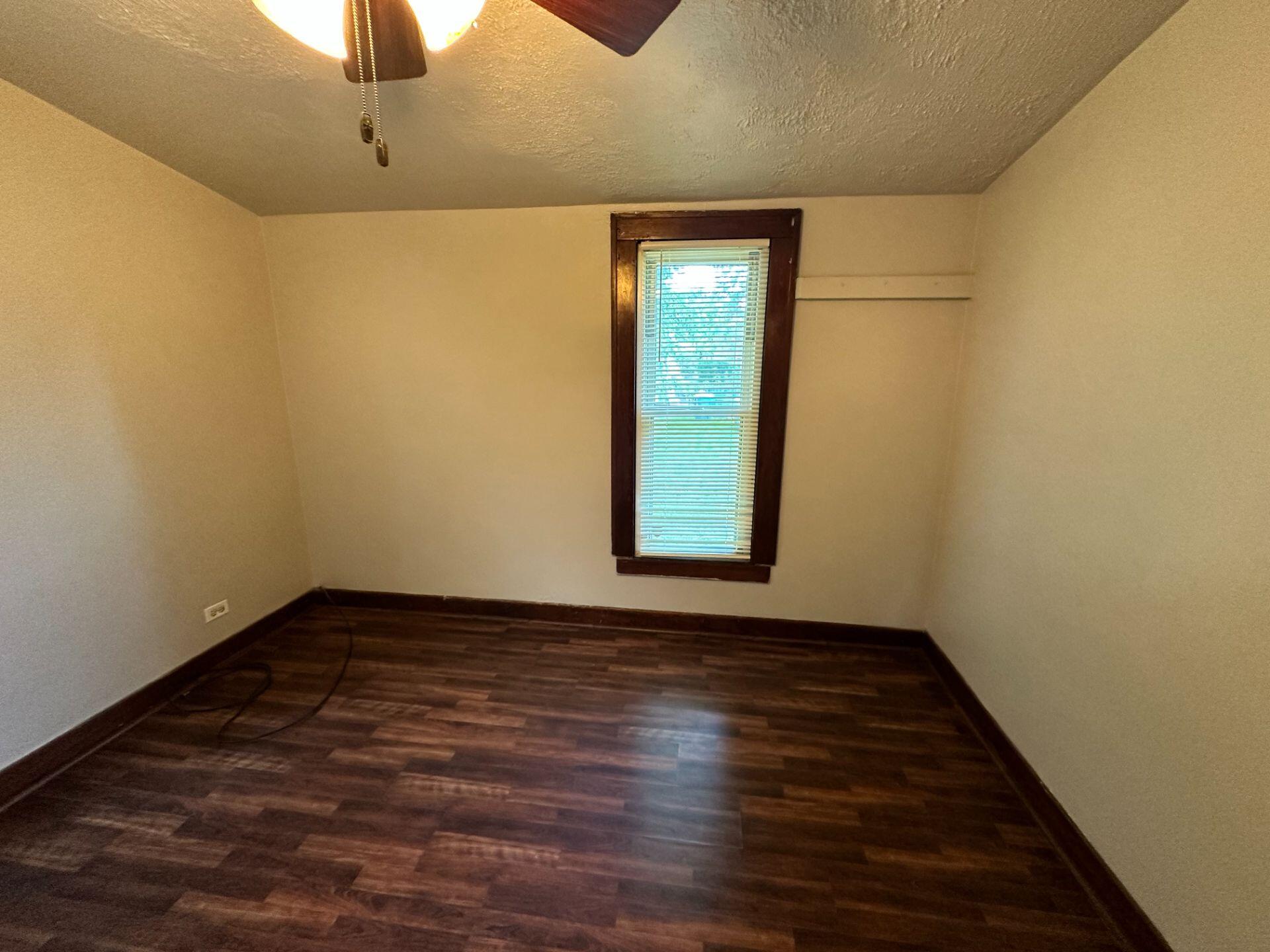 547 169th Street, Unit WEST Hammond, IN 46324 - Photo 6 of 7 a view of an empty room with window and wooden floor