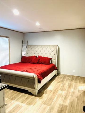 a bedroom with a bed and a night stand