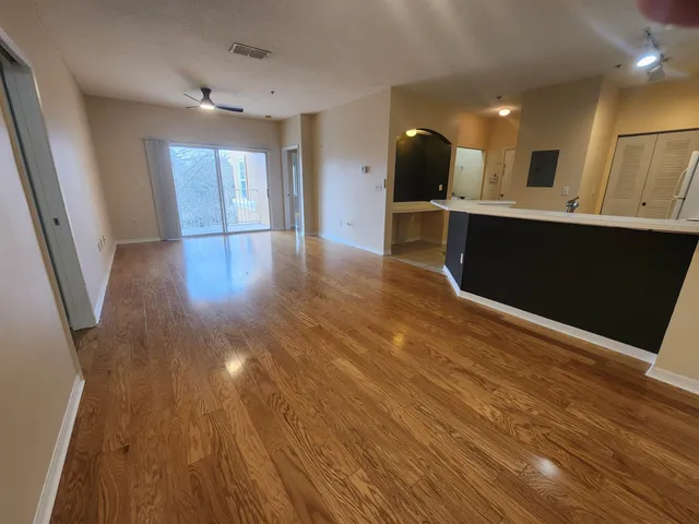 a view of a kitchen with a sink and a refrigerator
