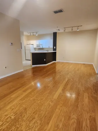 a view of a kitchen with a sink and a refrigerator
