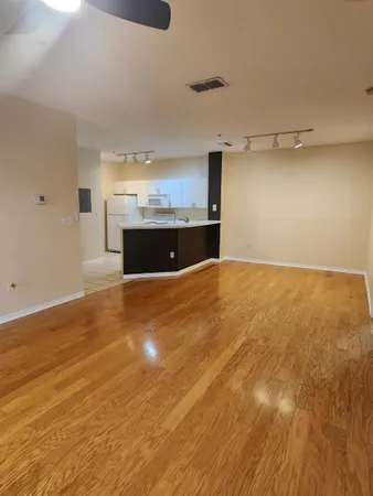 a view of a room with kitchen and window