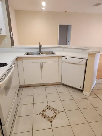 a utility room with washing machine and cabinets