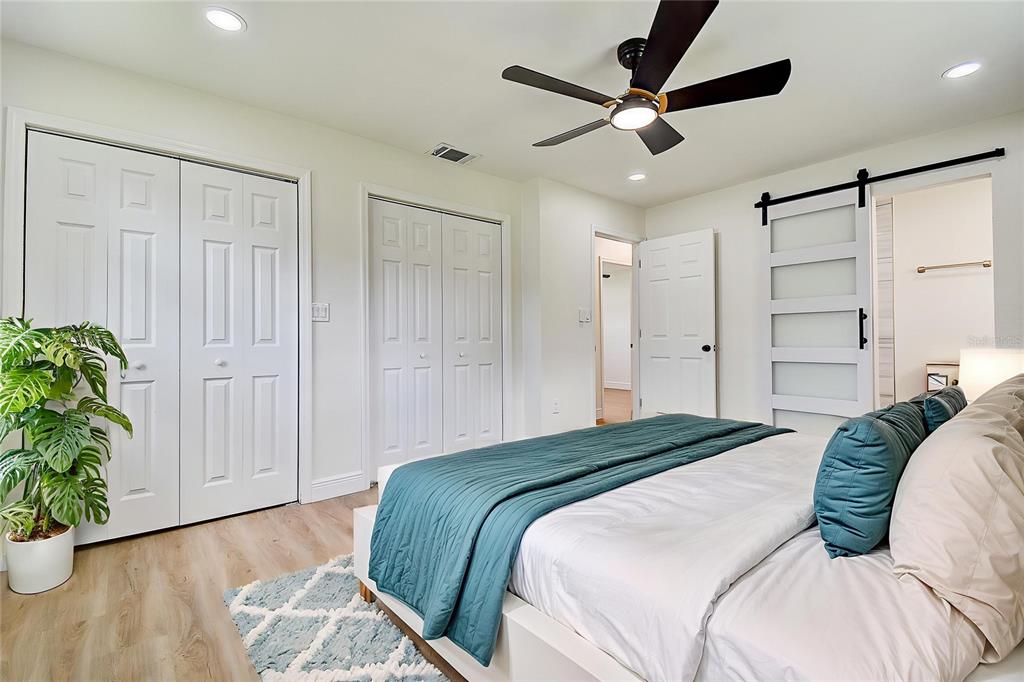 2015 Capri Road Valrico, FL 33594 - Photo 12 of 34 a spacious bedroom with a bed and a potted plant