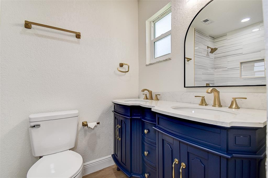 2015 Capri Road Valrico, FL 33594 - Photo 13 of 34 a bathroom with a toilet a sink and mirror