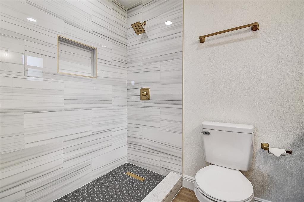2015 Capri Road Valrico, FL 33594 - Photo 15 of 34 a bathroom with a toilet and a shower
