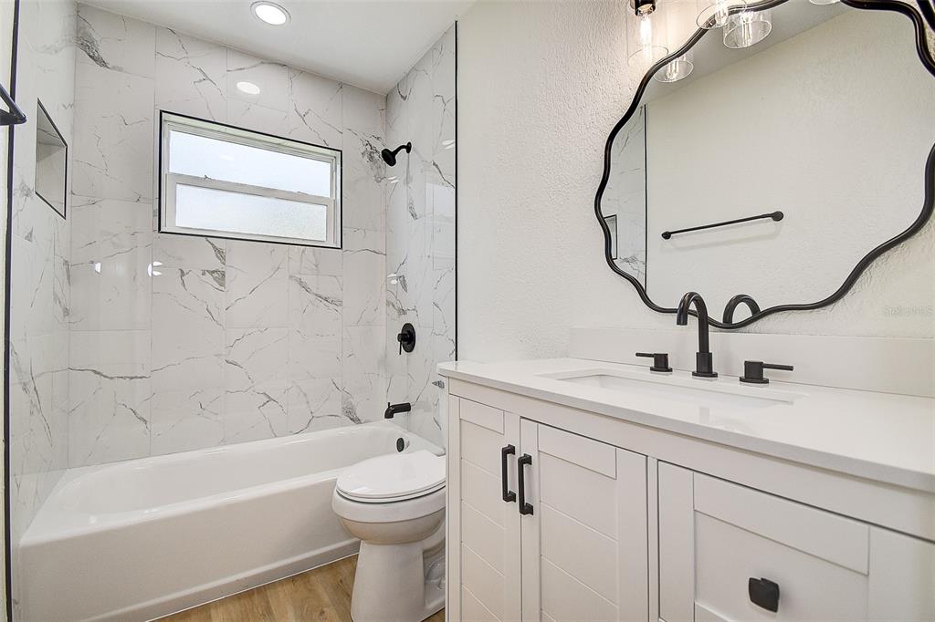 2015 Capri Road Valrico, FL 33594 - Photo 18 of 34 a bathroom with a sink a toilet and shower