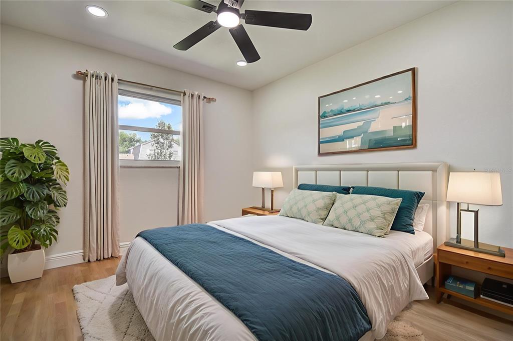 2015 Capri Road Valrico, FL 33594 - Photo 20 of 34 a bedroom with a large bed and a potted plant