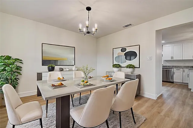 a view of a dining room with furniture wooden floor and chandelier