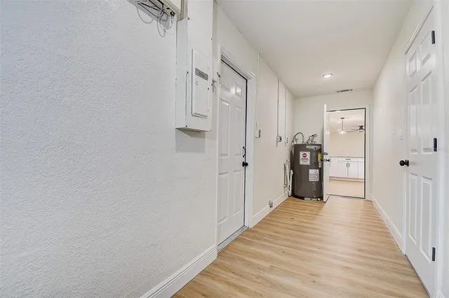 a view of a hallway with wooden floor