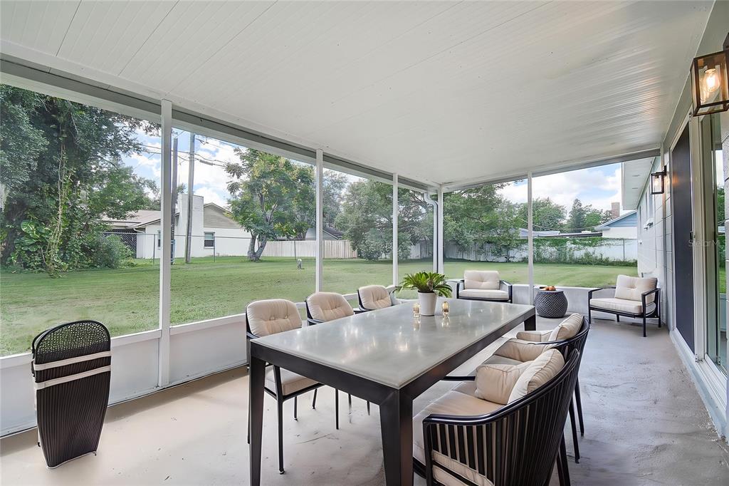 2015 Capri Road Valrico, FL 33594 - Photo 29 of 34 a view of a patio with a table chairs and a backyard