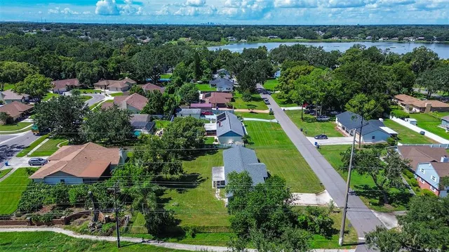 an aerial view of house with yard swimming pool and outdoor seating