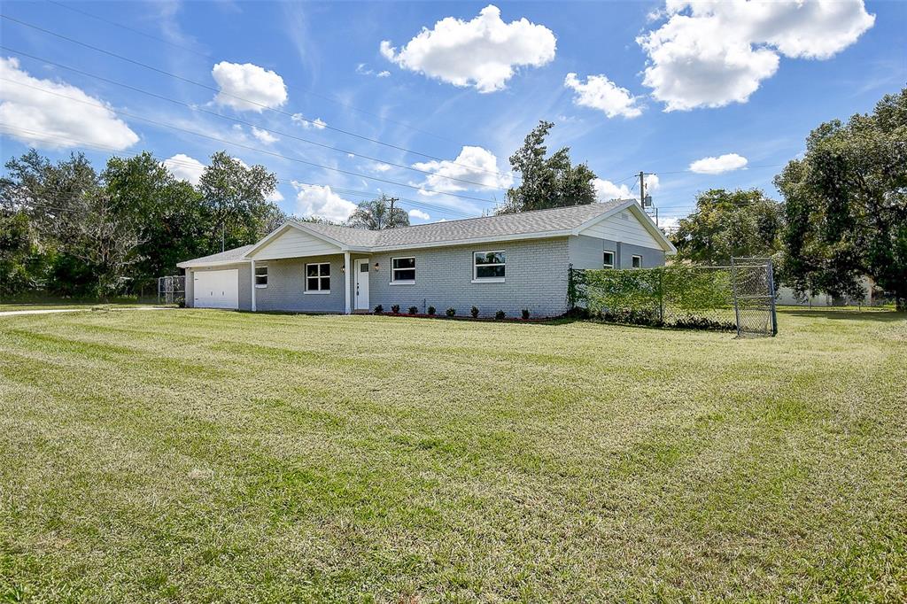 2015 Capri Road Valrico, FL 33594 - Photo 34 of 34 a view of a house with yard and sitting area