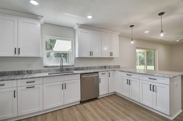 a kitchen with a sink window and cabinets