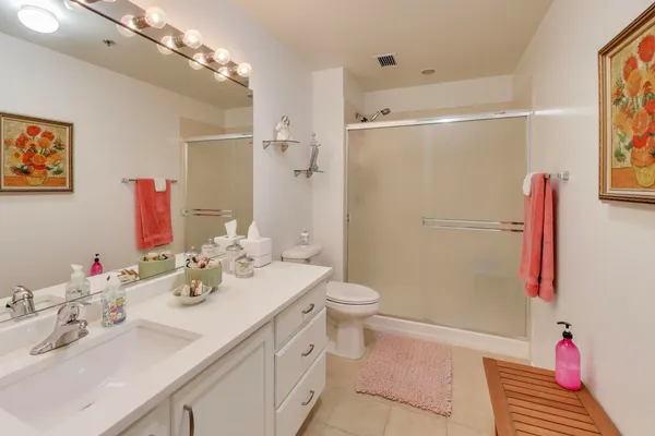 a bathroom with a sink vanity mirror and toilet
