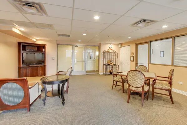 a dining room with furniture and a chandelier