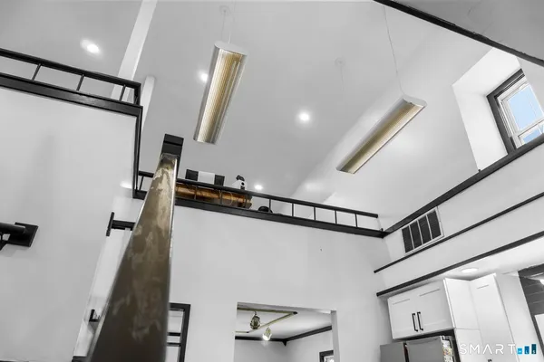 a view of a hallway with stairs