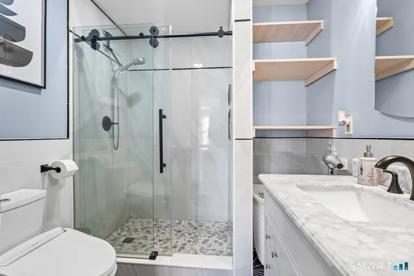 a bathroom with a sink toilet and shower