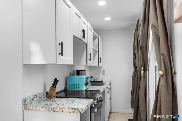 a kitchen with stainless steel appliances granite countertop a refrigerator and a stove