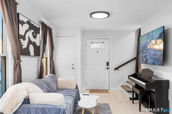 a living room with furniture and a flat screen tv
