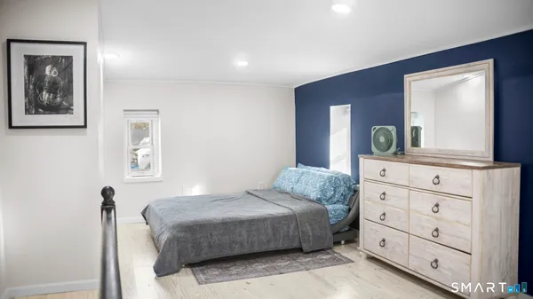 a bedroom with a bed and a dresser