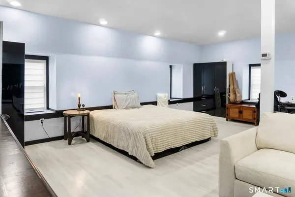 a bedroom with a bed and window