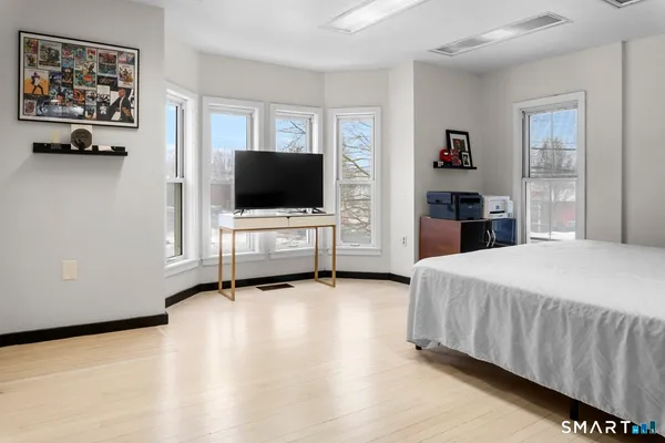 a bedroom with a bed and a flat screen tv