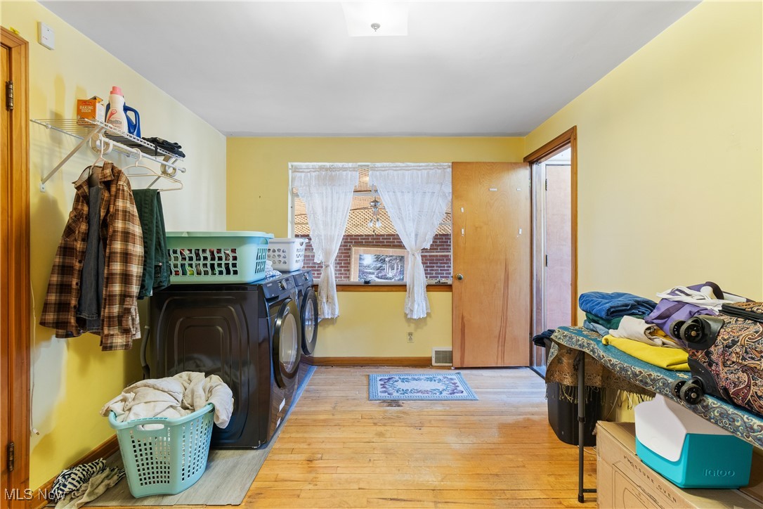 1527 Ridge Road Northwest Canton, OH 44703 - Photo 13 of 27 Laundry area featuring washing machine and dryer and light wood-type flooring