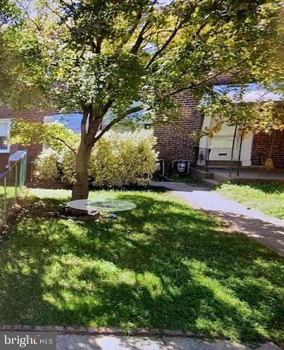 128 Margate Road Upper Darby, PA 19082 - Photo 1 of 12 a view of a patio with table and chairs a fire pit and a large tree