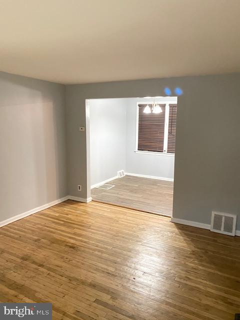 128 Margate Road Upper Darby, PA 19082 - Photo 3 of 12 a view of an empty room with wooden floor and a window