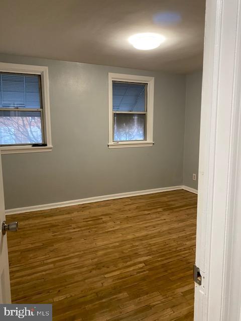 128 Margate Road Upper Darby, PA 19082 - Photo 10 of 12 a view of an empty room with window and wooden floor