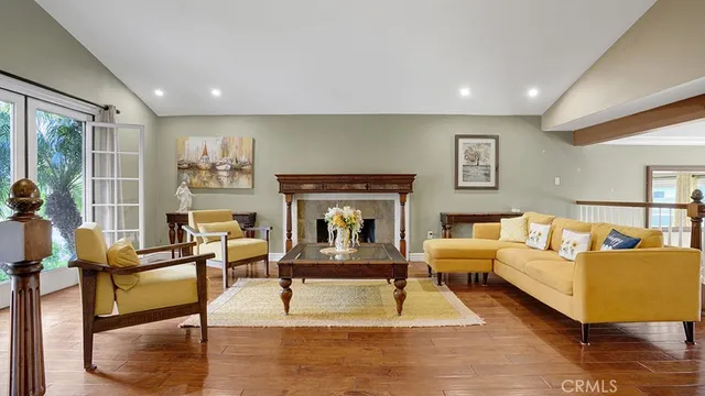 a living room with furniture wooden floor and a fireplace