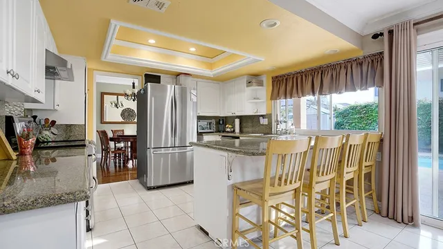 a kitchen with stainless steel appliances granite countertop a refrigerator and a sink