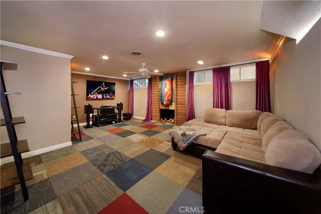 a living room with furniture a rug and a flat screen tv