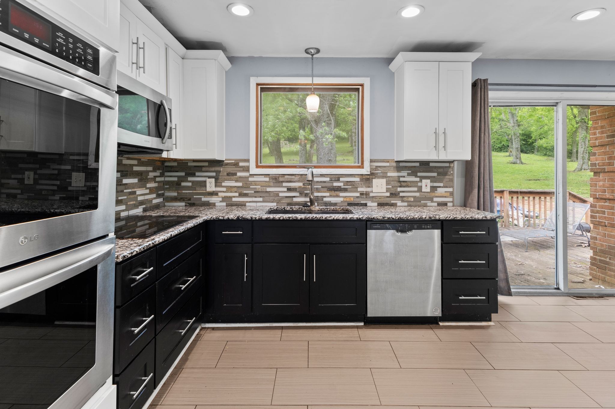 483 Franklin Road Franklin, TN 37069 - Photo 14 of 48 a kitchen with stainless steel appliances granite countertop a stove a sink and a microwave