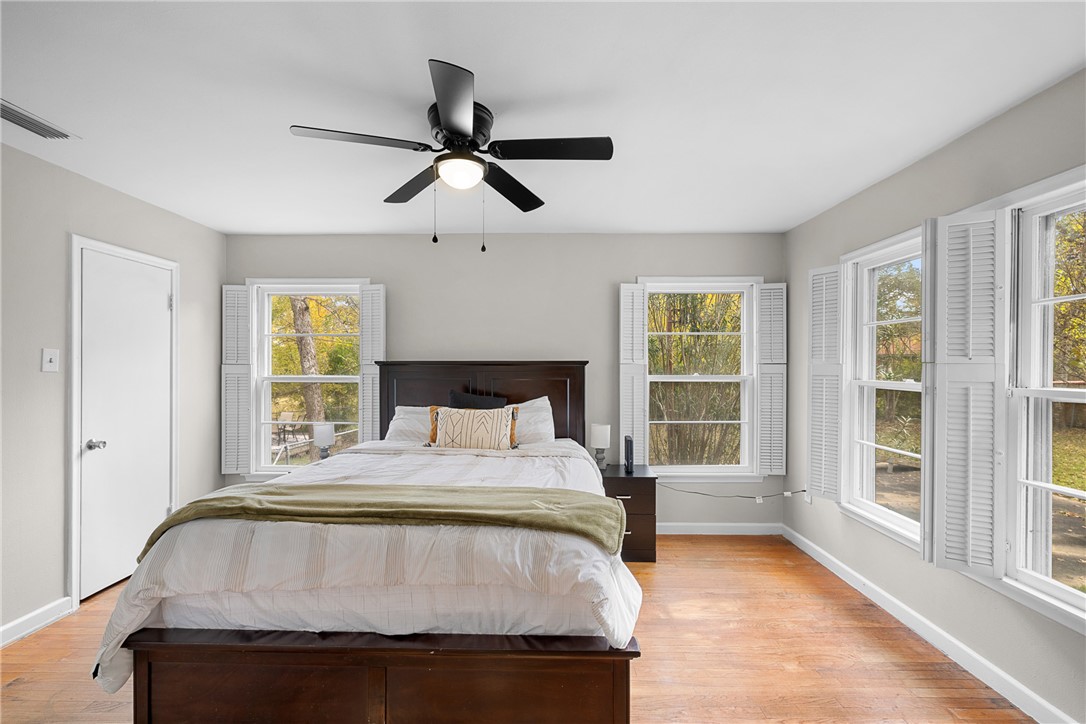 909 Enfield Street Bryan, TX 77802 - Photo 18 of 45 Bedroom with wood floors and natural light.