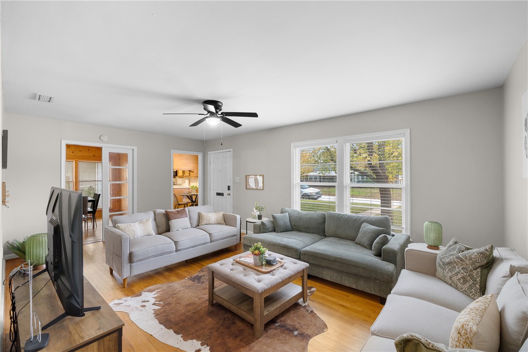 909 Enfield Street Bryan, TX 77802 - Photo 2 of 45 Bright living room space with natural wood floors.