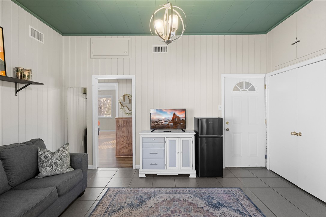 909 Enfield Street Bryan, TX 77802 - Photo 26 of 45 Living room attached to the primary bedroom. With mini-fidge.