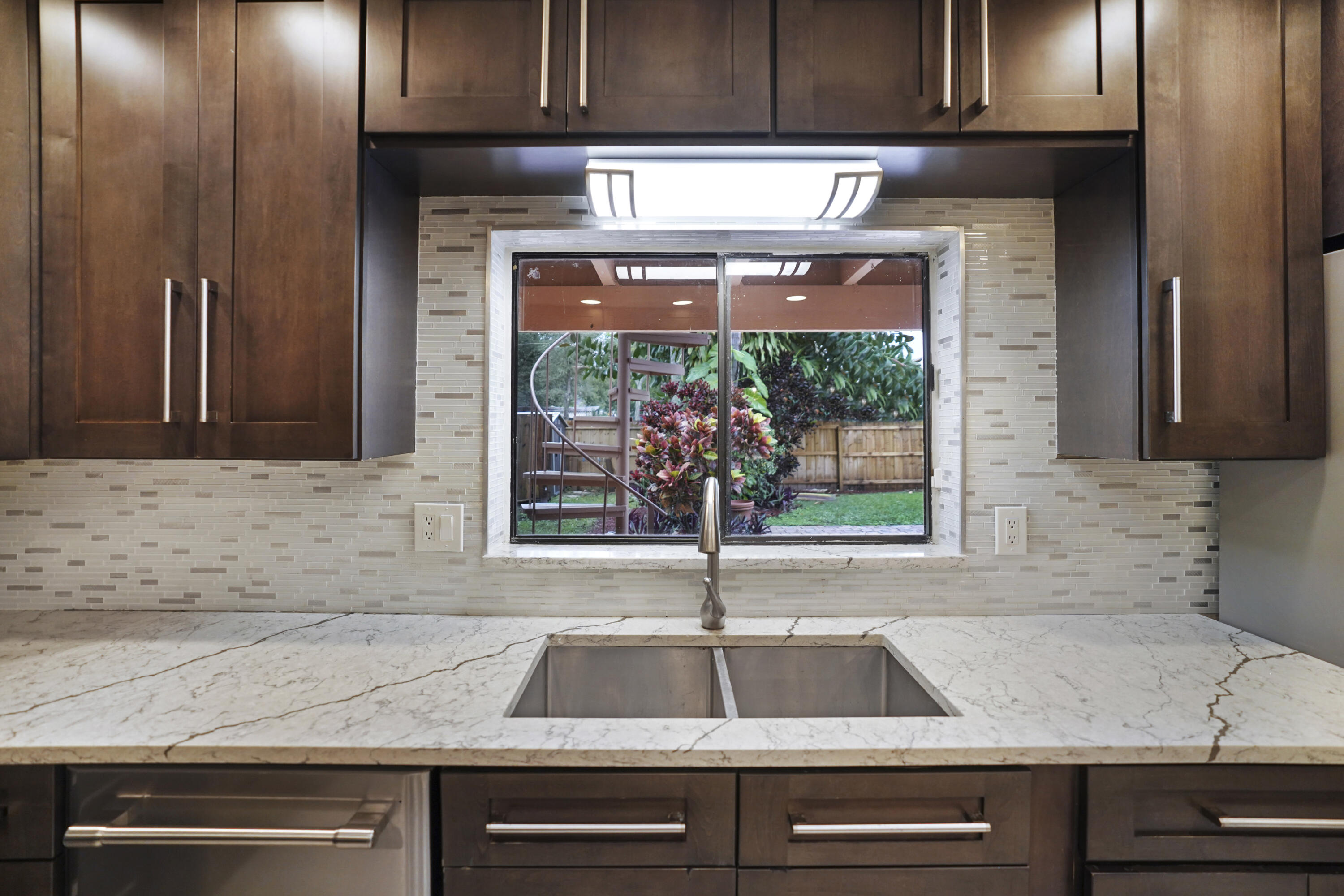 2674 Northwest 41st Street Boca Raton, FL 33434 - Photo 16 of 48 a kitchen with a sink and a window