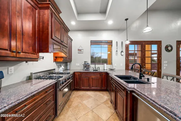 a kitchen with stainless steel appliances granite countertop a stove and a sink