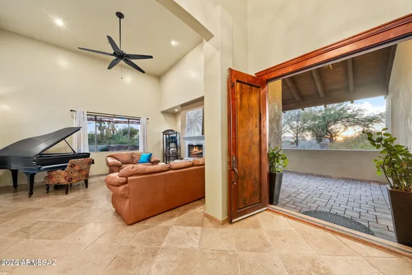 a living room with furniture fireplace and a large window